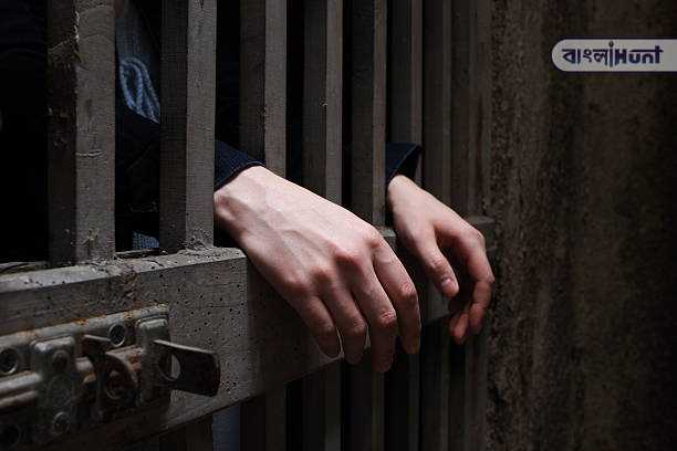 woman hands on cage bars