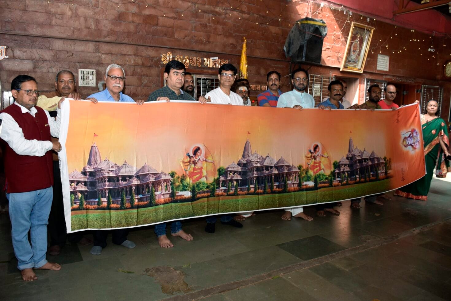 lalit sharma and rakesh jain hold a saree with a print of ram temple and lord ram that will be sent free of cost to all the ram temples of india